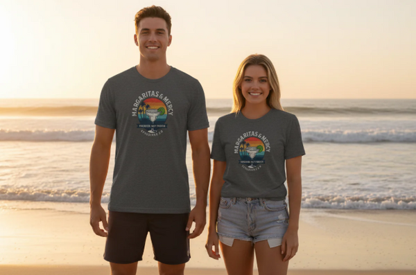 Two people wearing gray t-shirts with a logo on a beach at sunset.
