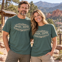 Colorado lifestyle - Walk by Faith scenic graphic, Blue Spruce shirts worn by a man and woman at a mountain-town trailhead
