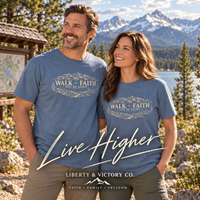 Couple in Blue Jean Walk by Faith shirts at a Colorado lakeside trailhead with handwritten Live Higher and Liberty & Victory mountain logo